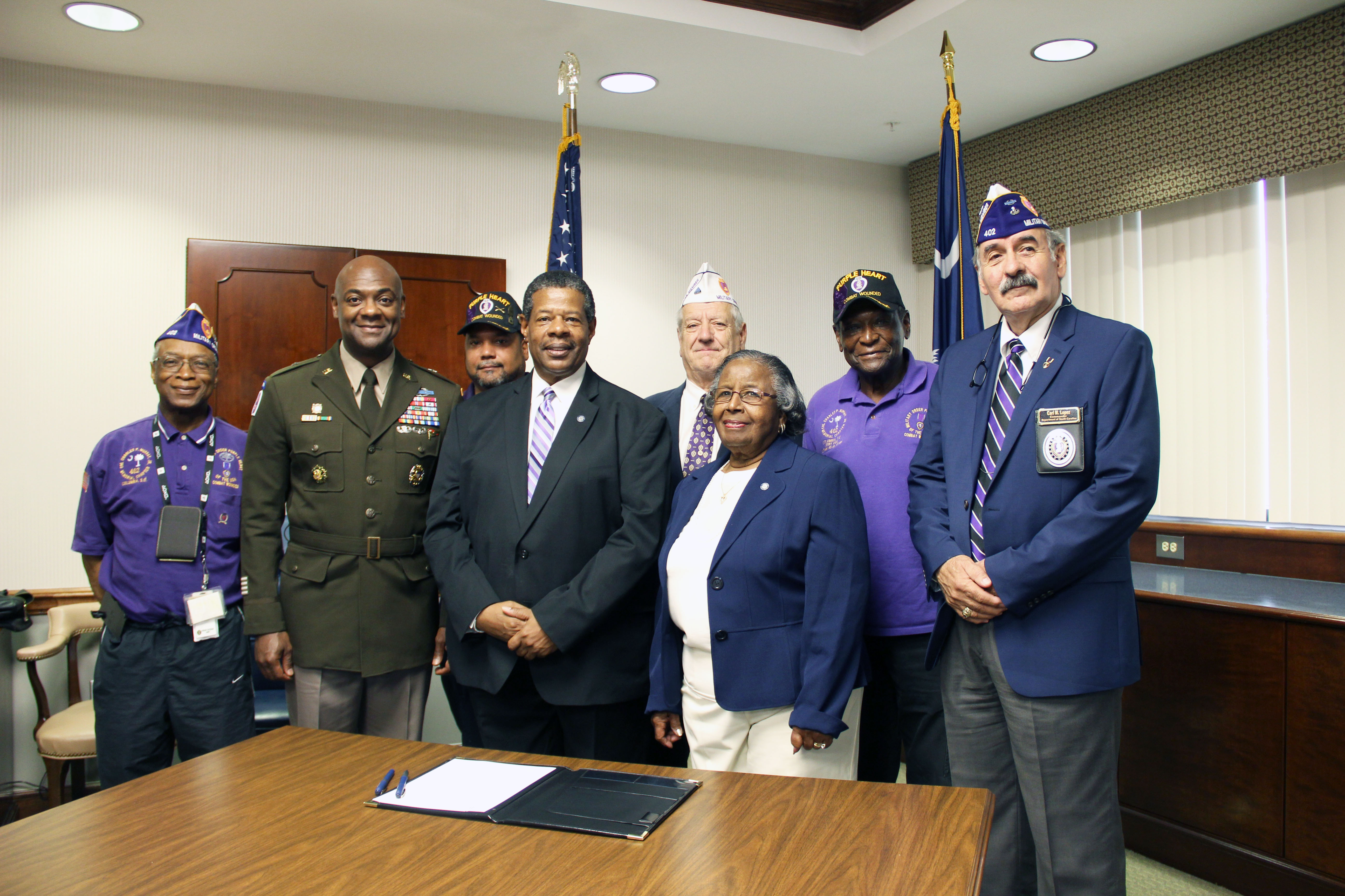 MTC Leadership accepting designation as a purple heart college.