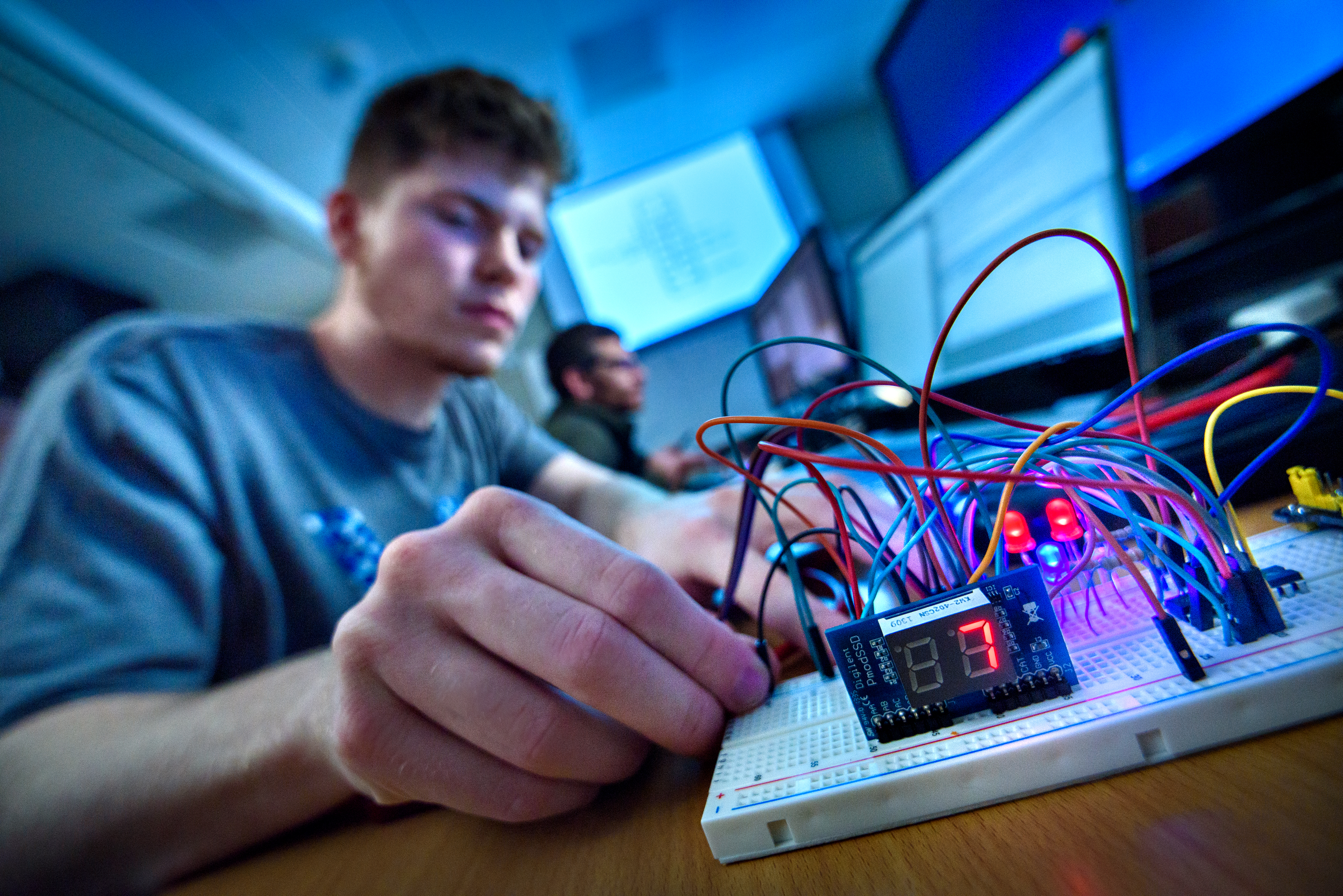 Image of student working with computer wires.