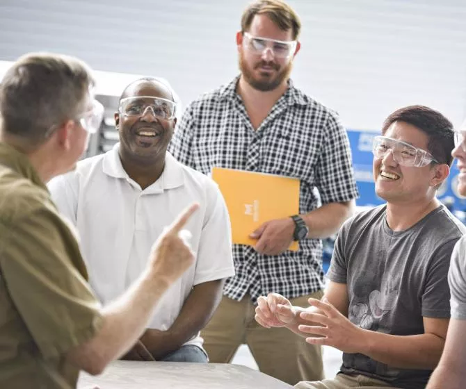 Student watching employees