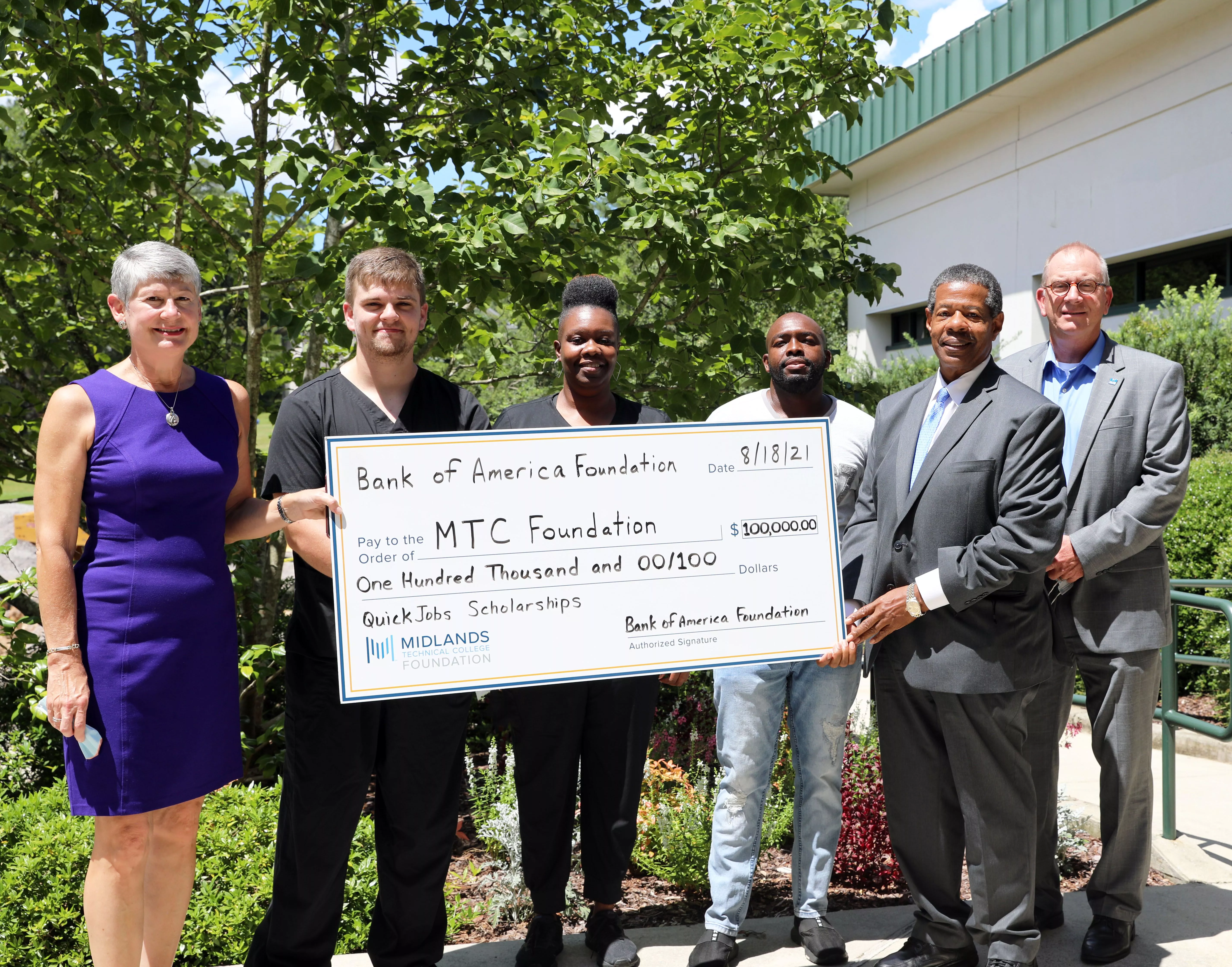 Group of people holding a large donation check from Bank of America