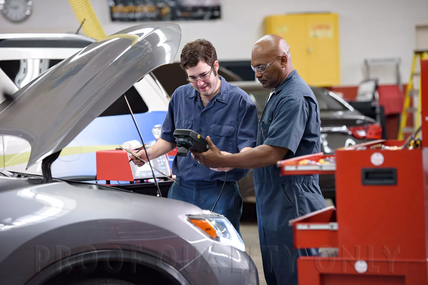 Two students working on an automobile