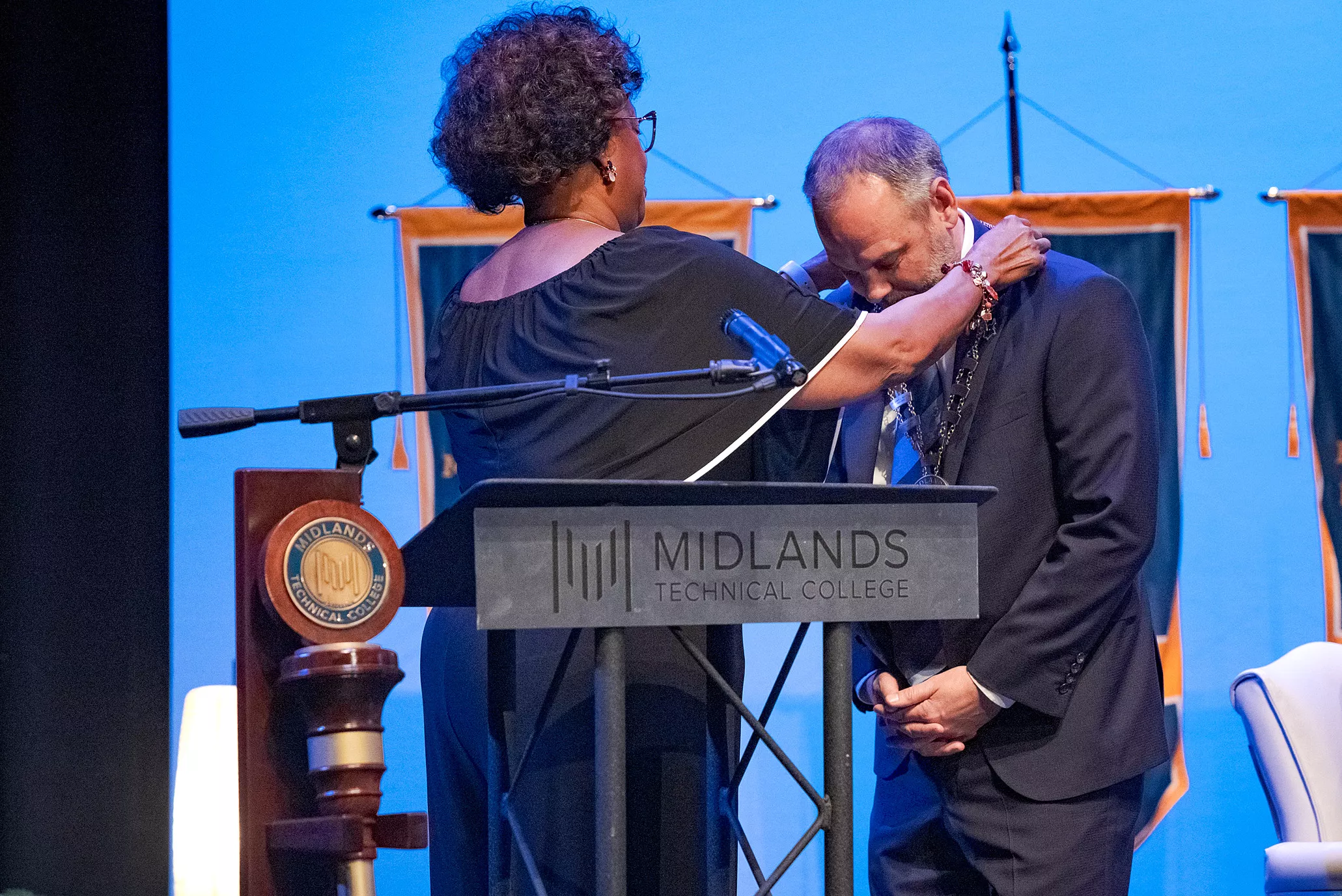 MTC Commission Chairwoman Sandra Jackson places the presidential medallion on Dr. Gregory D. Little. 