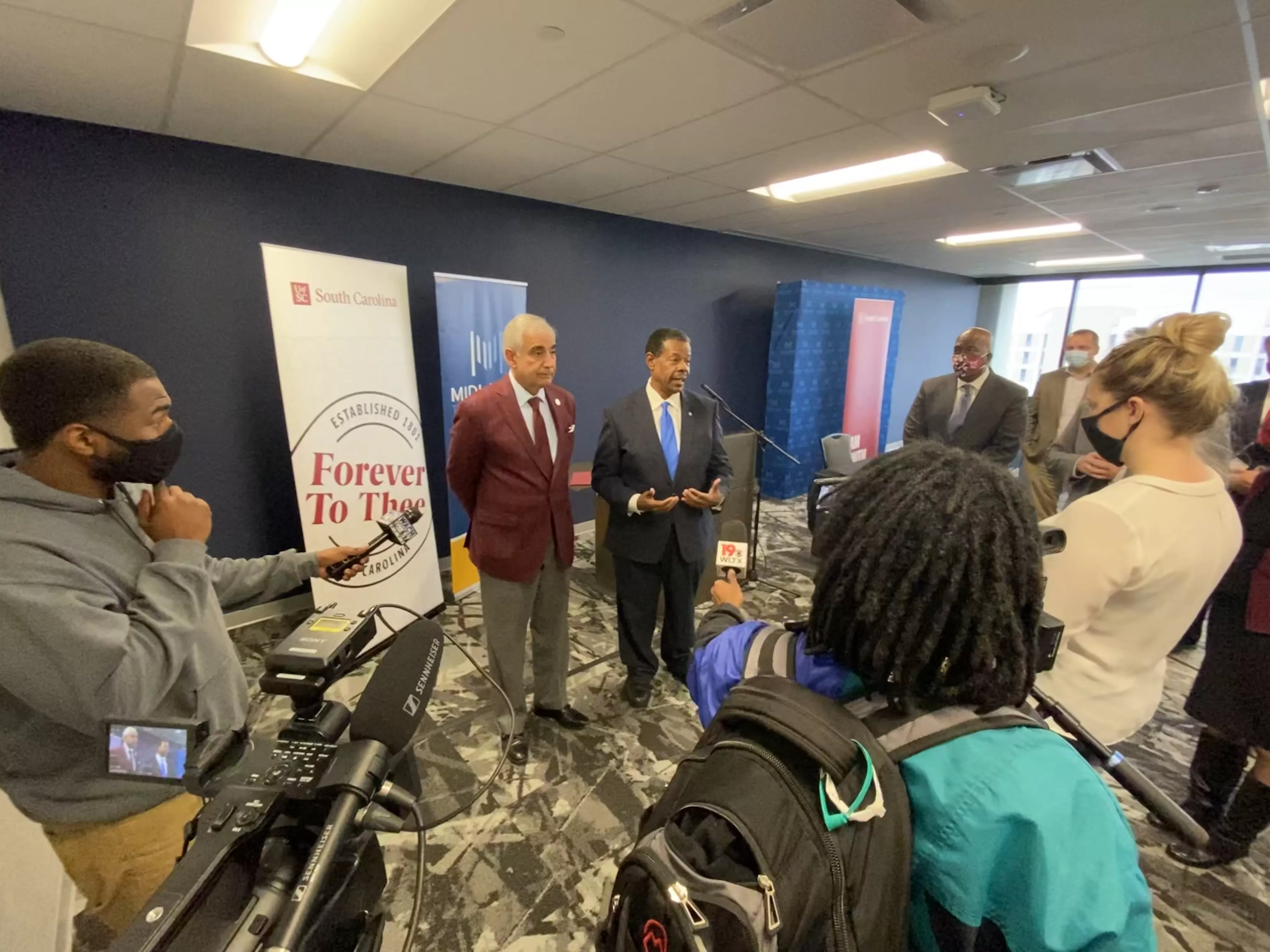 University of South Carolina President Dr. Harris Pastides and Midlands Technical College President Dr. Ron Rhames speak with journalist.