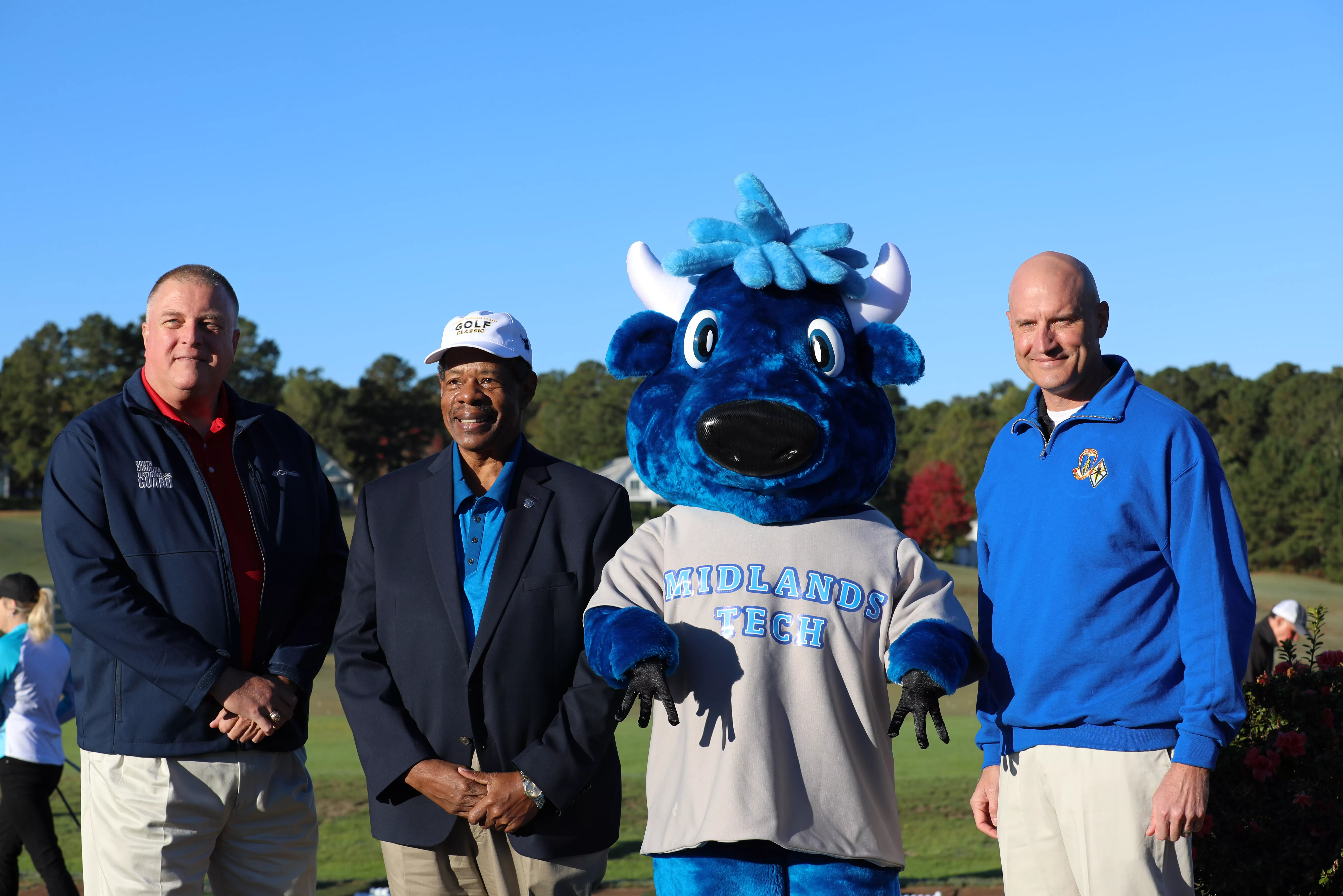 MTC President Dr. Ron Rhames with MTC Mascot Mav, Maj. Gen. McCarty, and Brig. Gen. Michaelis.